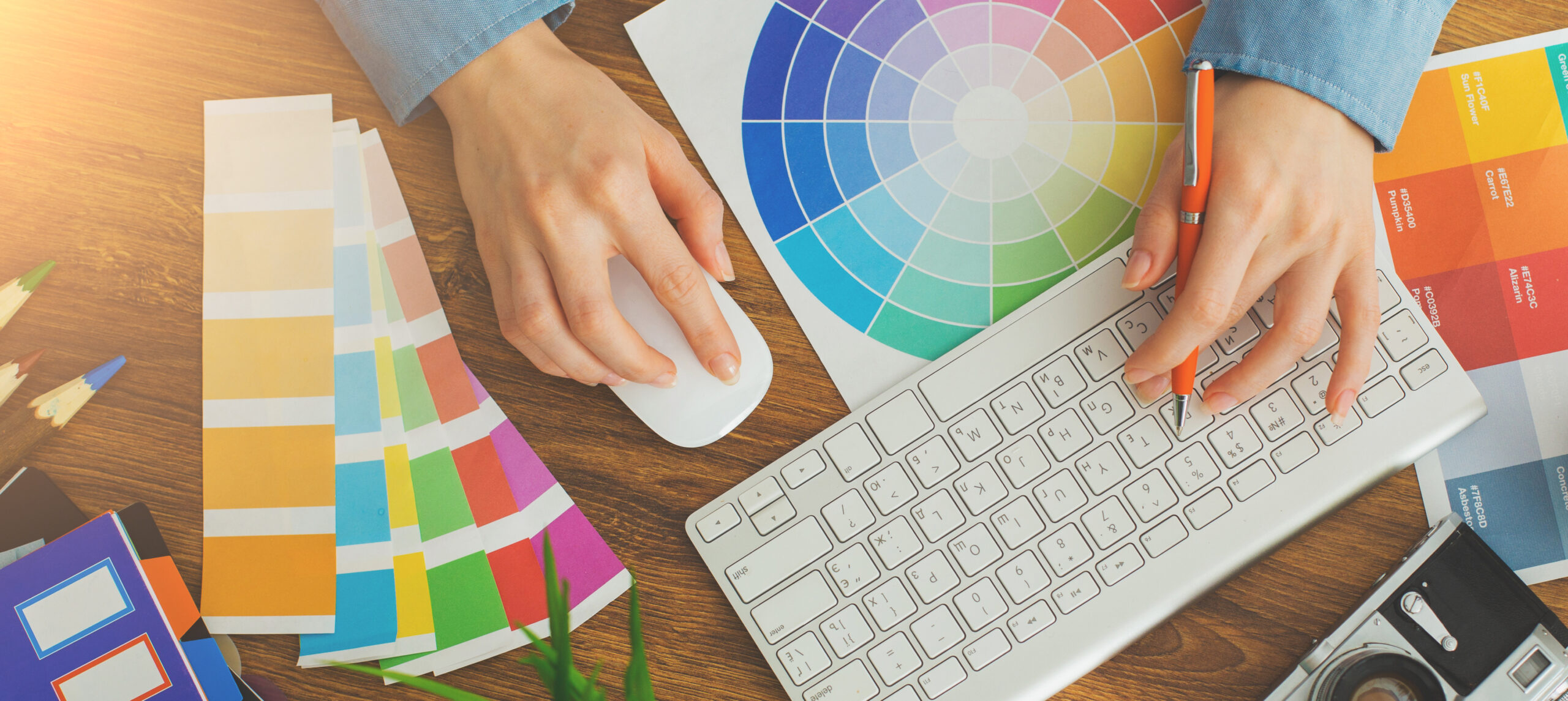 Young cute Graphic designer using graphics tablet to do his work at desk view from above