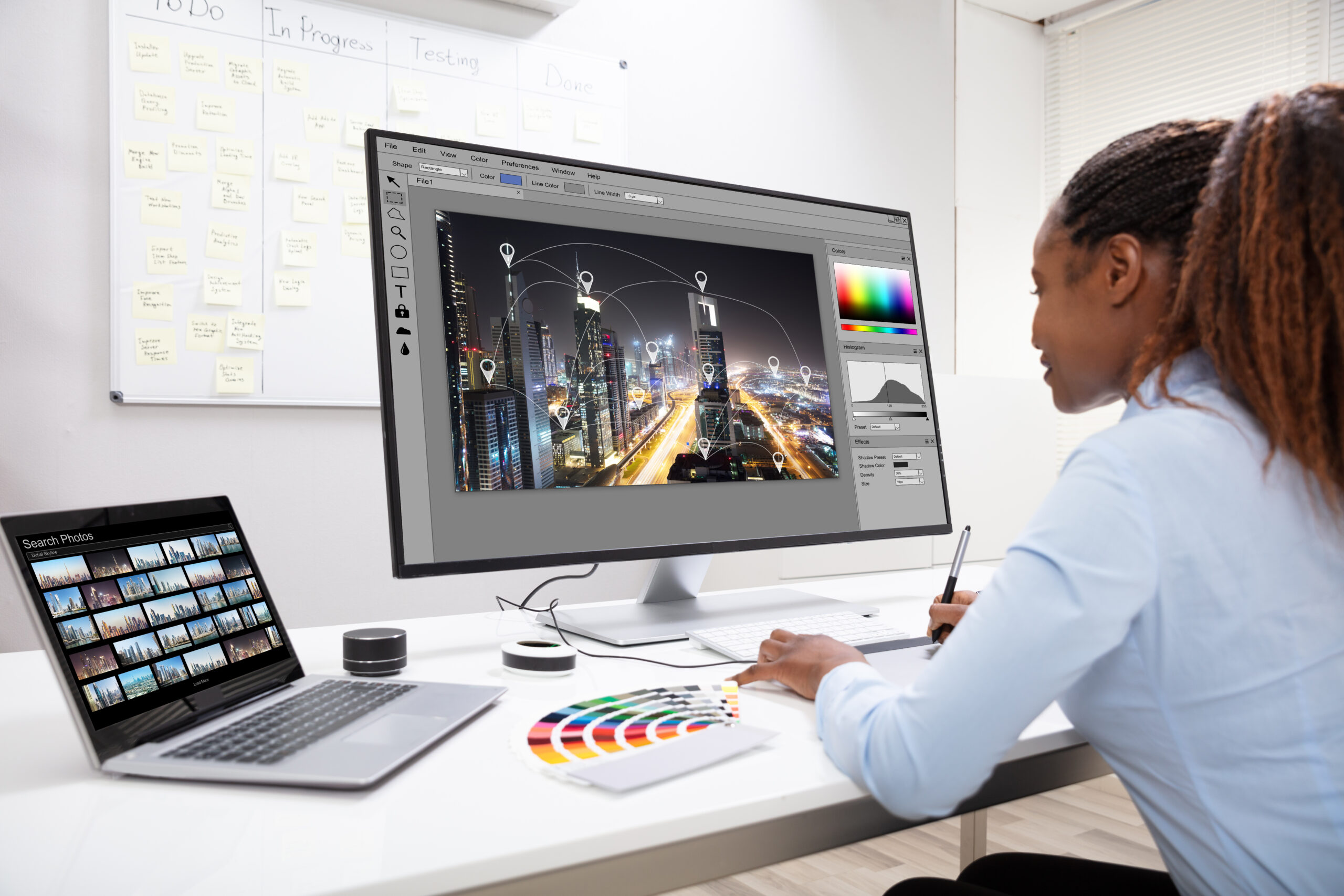 Young Female Designer Editing Photos On Computer In Office